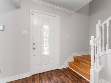 16606 Oxnard Lane, Friendswood, TX 77546 Welcoming entryway featuring beautiful wood-look flooring, a decorative glass front door, and a staircase with classic white railing.