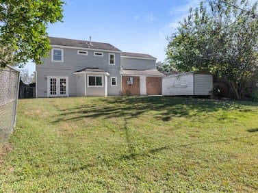 16606 Oxnard Lane, Friendswood, TX 77546 Spacious fenced backyard offering plenty of room for outdoor activities, with an extended concrete patio, mature trees, and no back neighbors for added privacy.
