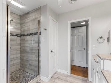 16606 Oxnard Lane, Friendswood, TX 77546 Primary bathroom featuring a beautifully tiled walk-in shower with glass enclosure and granite countertops.