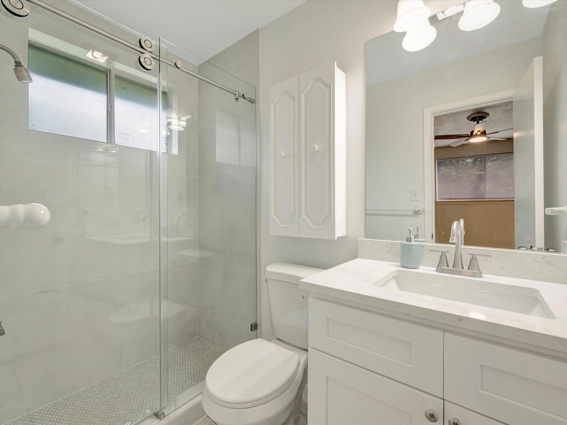 1003 Richvale Lane, Houston, TX 77062 Primary bath with walk-in shower, Glass door, porcelain tile and quartz countertop