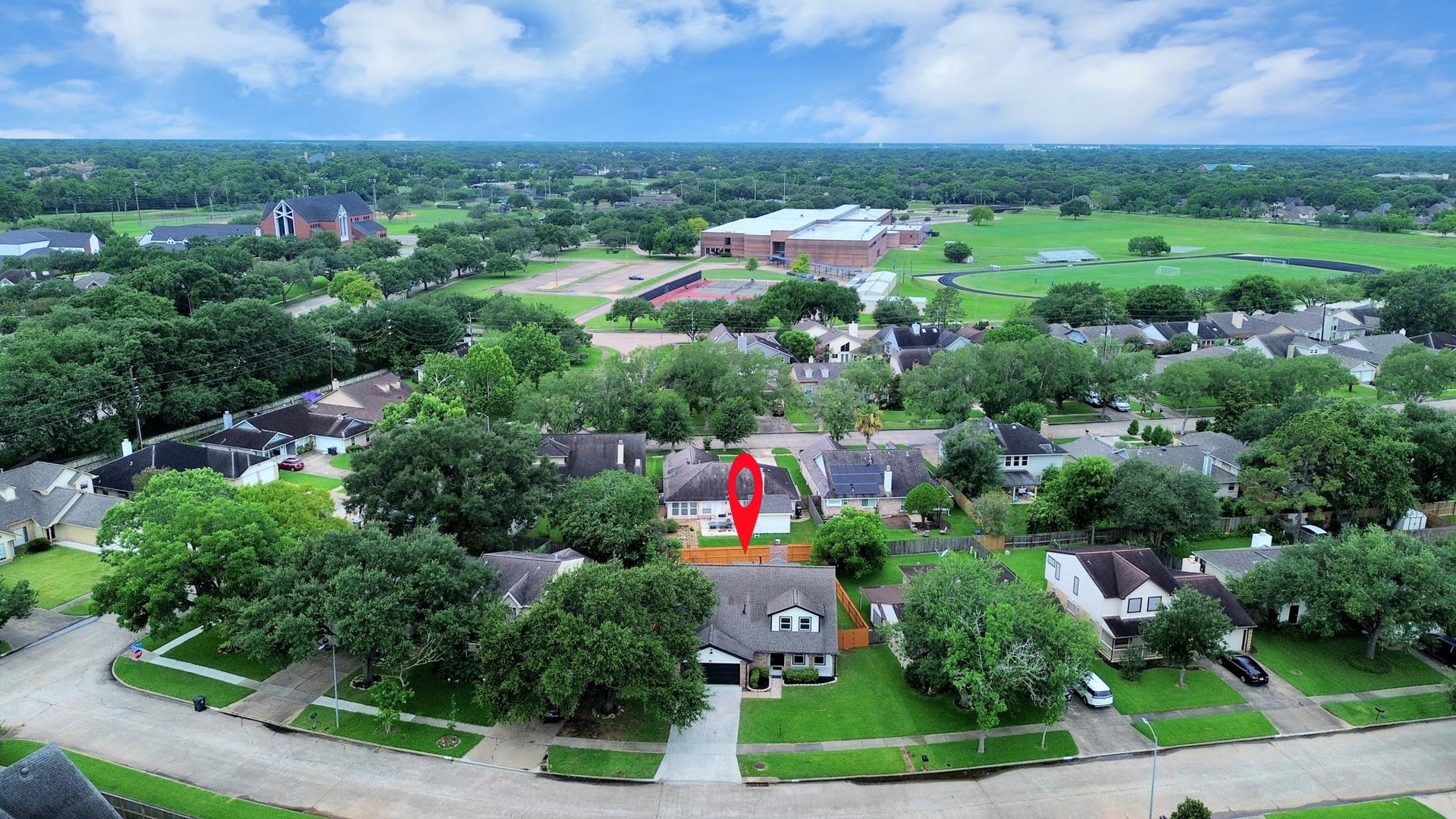 3234 Pebble Lake Drive, Sugar Land, TX 77479 Expansive aerial view showcasing a picturesque neighborhood, highlighting lush greenery, spacious streets, and the proximity to local amenities.