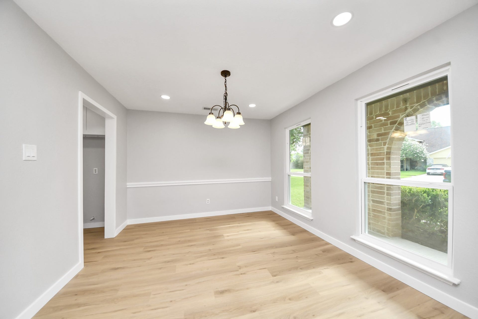 3234 Pebble Lake Drive, Sugar Land, TX 77479 This bright dining area features fresh gray walls, light wood flooring, and a central chandelier. Large windows offer plenty of natural light and views of the yard.