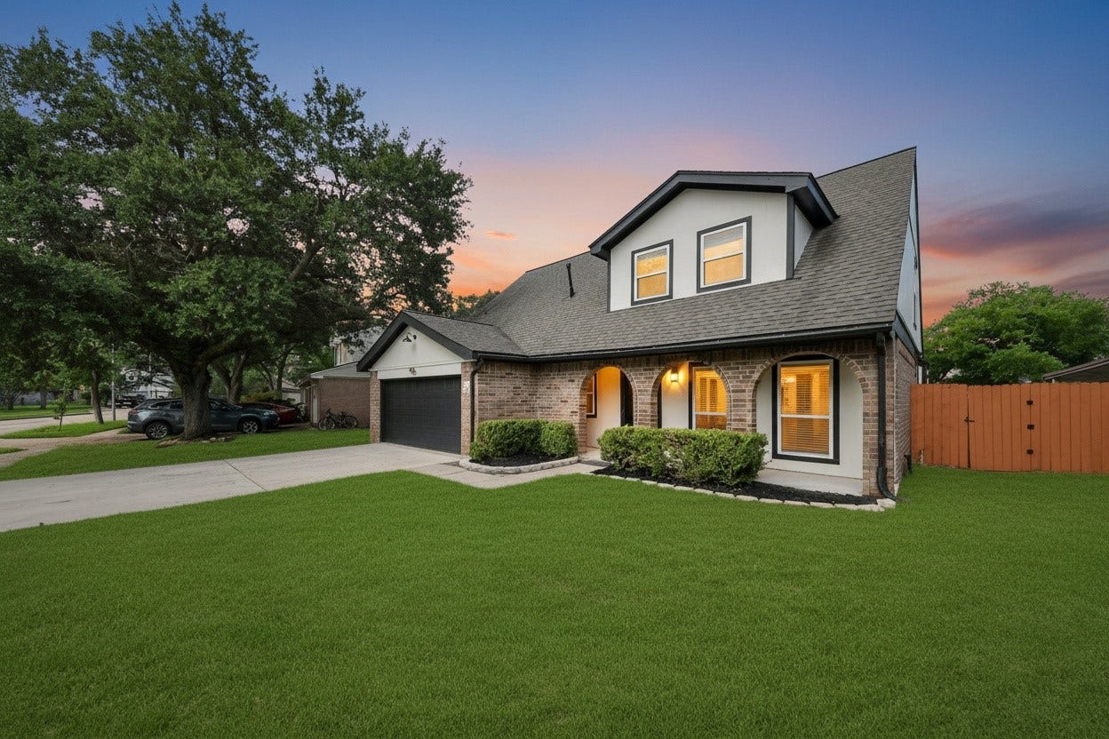 3234 Pebble Lake Drive, Sugar Land, TX 77479 Charming two-story brick home with a lush front yard, spacious driveway, and elegant arched porch leading to a two-car garage.