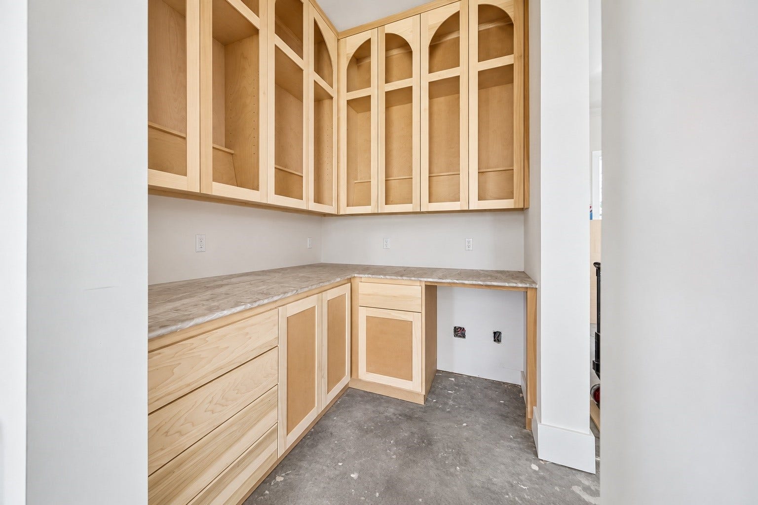 Positioned just off the dining room, the dedicated bar features extensive custom cabinetry, generous counter space, and arched millwork details. Designed for effortless entertaining while keeping drinks and serving essentials separate from the main kitchen. **Current Construction as of 9/11/26