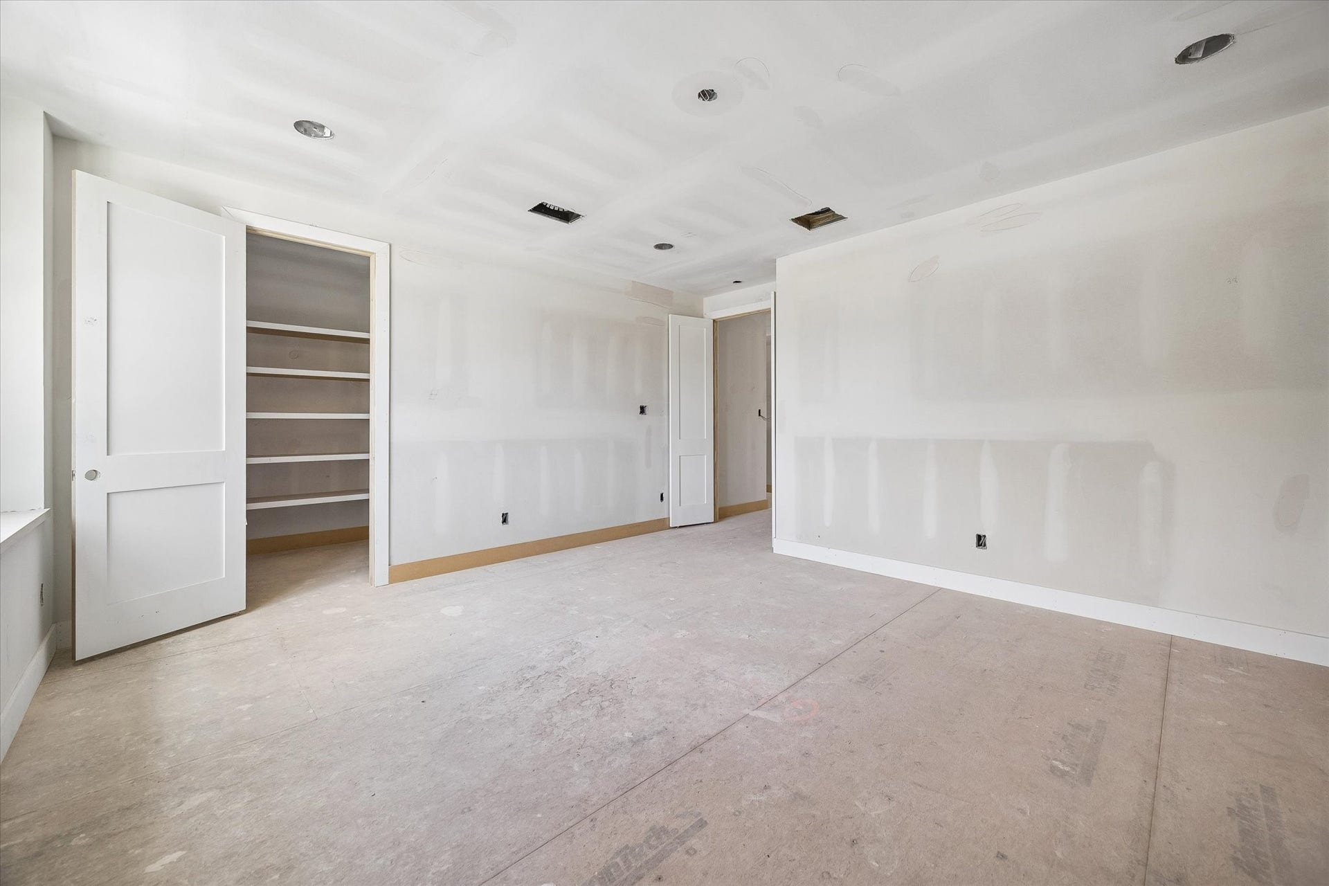 Alternate view of the game room highlights a dedicated storage closet with built in shelving, keeping games, media and everyday extras neatly tucked away. The generous footprint leaves plenty of room to create separate areas for lounging and play. **Current Construction as of 9/11/26