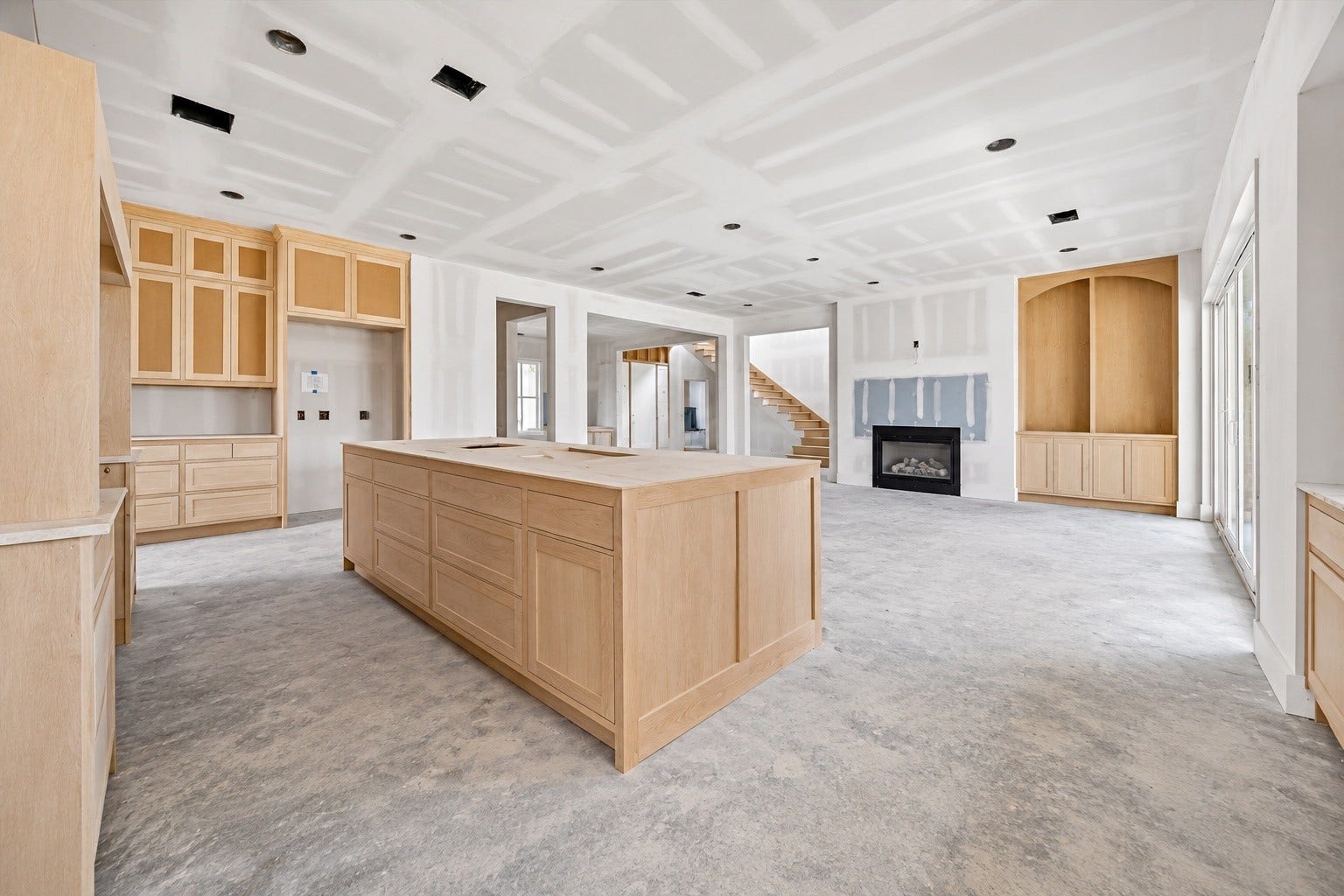 Custom cabinetry wraps the kitchen with an oversized island providing a substantial centerpiece for prep, gathering, and entertaining. **Current Construction as of 9/11/26