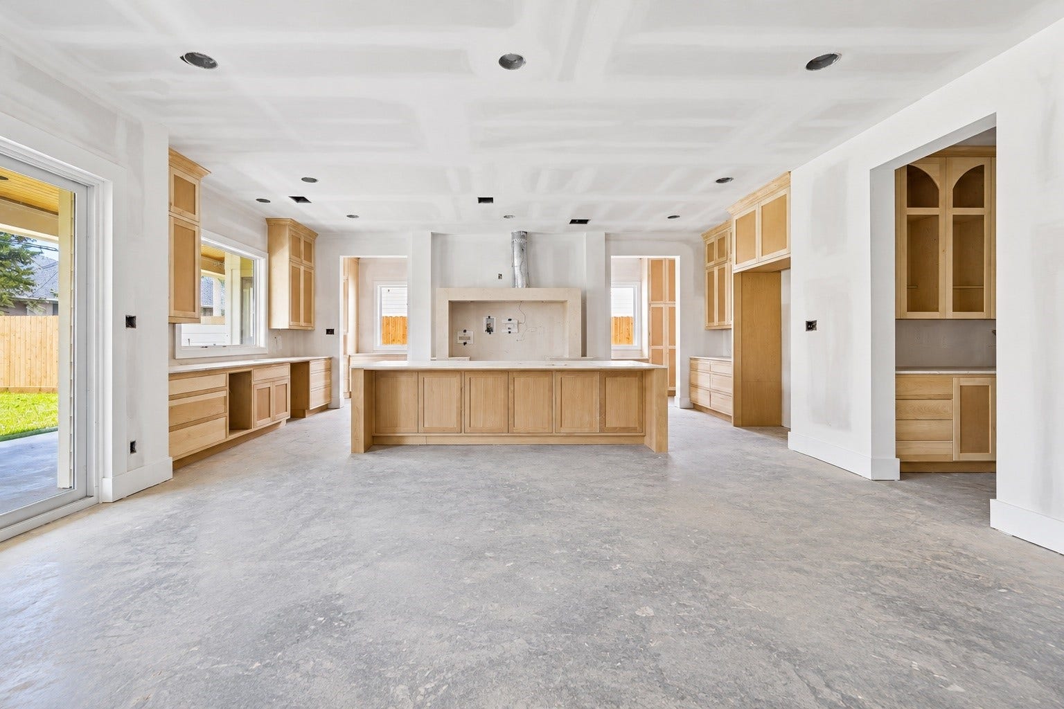 This open concept design brings the great room and kitchen together around an oversized island, with extensive custom cabinetry and direct access to the covered veranda. A dedicated scullery just beyond the kitchen keeps prep and storage tucked away from the main living space. **Current Construction as of 9/11/26