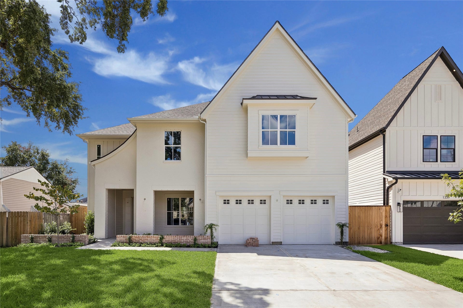 Clean architectural lines and a steep front gable give this Harvard Homes residence a timeless presence, while mixed exterior textures and a recessed entry add dimension and character. **Current Construction as of 9/11/26