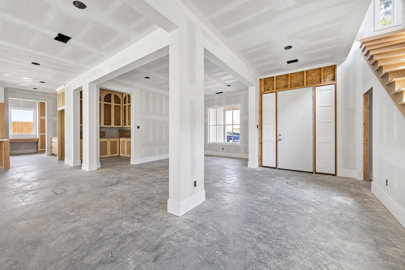 A dramatic entry introduces the home with soaring ceilings, clean architectural lines, and wide openings that create an immediate sense of scale. Sightlines extend into the dining room and towards the kitchen area, showcasing Harvard Homes emphasis on an open, connected floor plan. **Current Construction as of 9/11/26