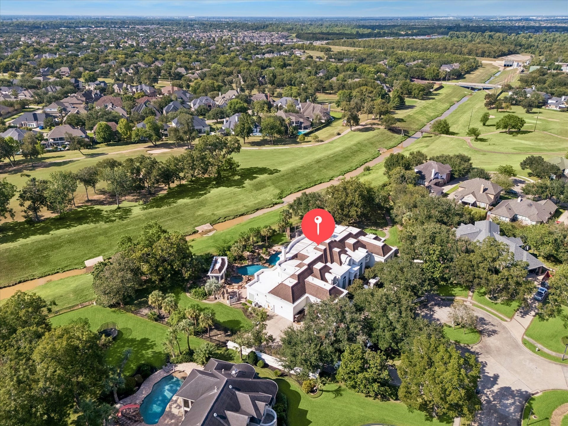 1822 FOREST GATE CIRCLE, Sugar Land, TX 77479 THIS AERIAL VIEW SHOWCASES THE HOMES GENEROUS LOT, BACKYARD POOL, AND DIRECT GOLF COURSE SETTING WITHIN GREATWOOD ESTATES.