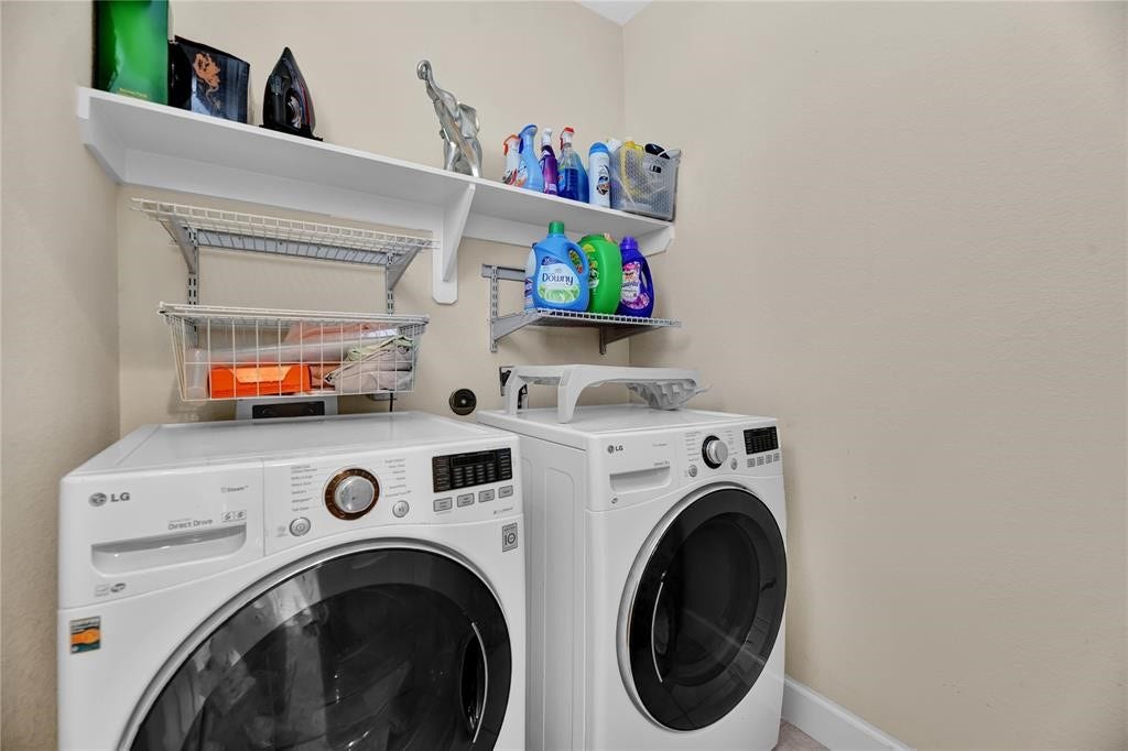 14502 San Pietro Drive, Houston, TX 77070 Laundry room complemented by convenient shelving for storage and organization!