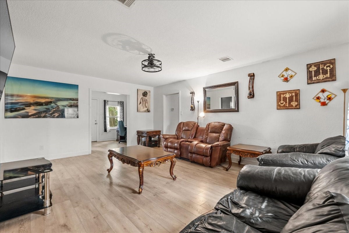 5201 Main Street, Santa Fe, TX 77510 The open family room sits at the heart of the home, seamlessly connecting the kitchen, bedrooms, and flexible study or dining area for an easy, functional flow.