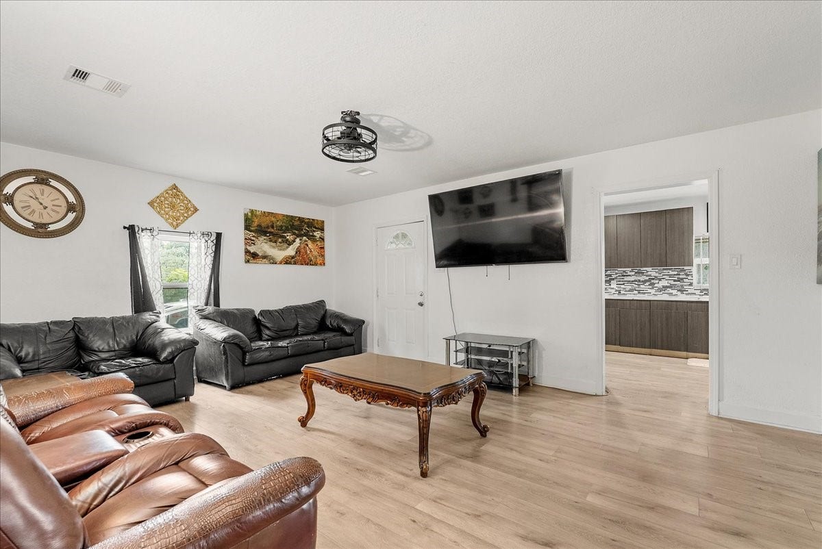 5201 Main Street, Santa Fe, TX 77510 Centrally located and full of possibility, this family room keeps you connected to the kitchen, bedroom hallway, and adjoining study or dining area.