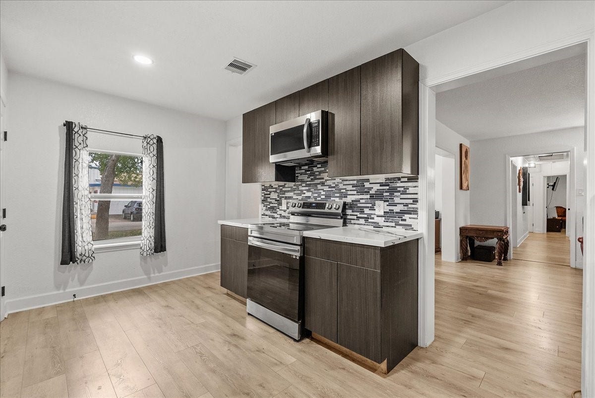 5201 Main Street, Santa Fe, TX 77510 Enjoy the added charm of the kitchen windows, bringing in natural light and creating a bright, inviting atmosphere for everyday cooking and gathering.