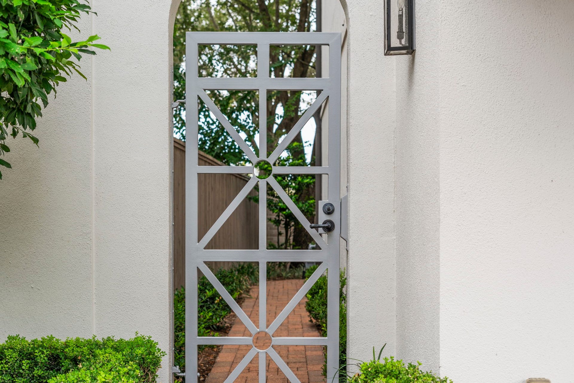 15931 Morgan Street, Sugar Land, TX 77478 Striking and modern, this artistic gate opens to the side yard and private entrance, adding an extra layer of security while complementing the homes contemporary architectural design.