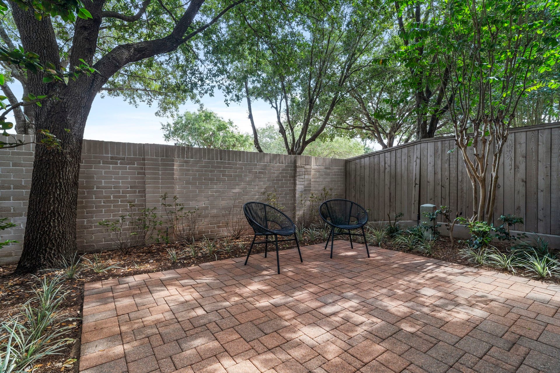 15931 Morgan Street, Sugar Land, TX 77478 A spacious, shaded brick patio offers an outdoor retreat. This inviting space extends the homes living area outdoors while providing a serene setting for relaxing or entertaining.