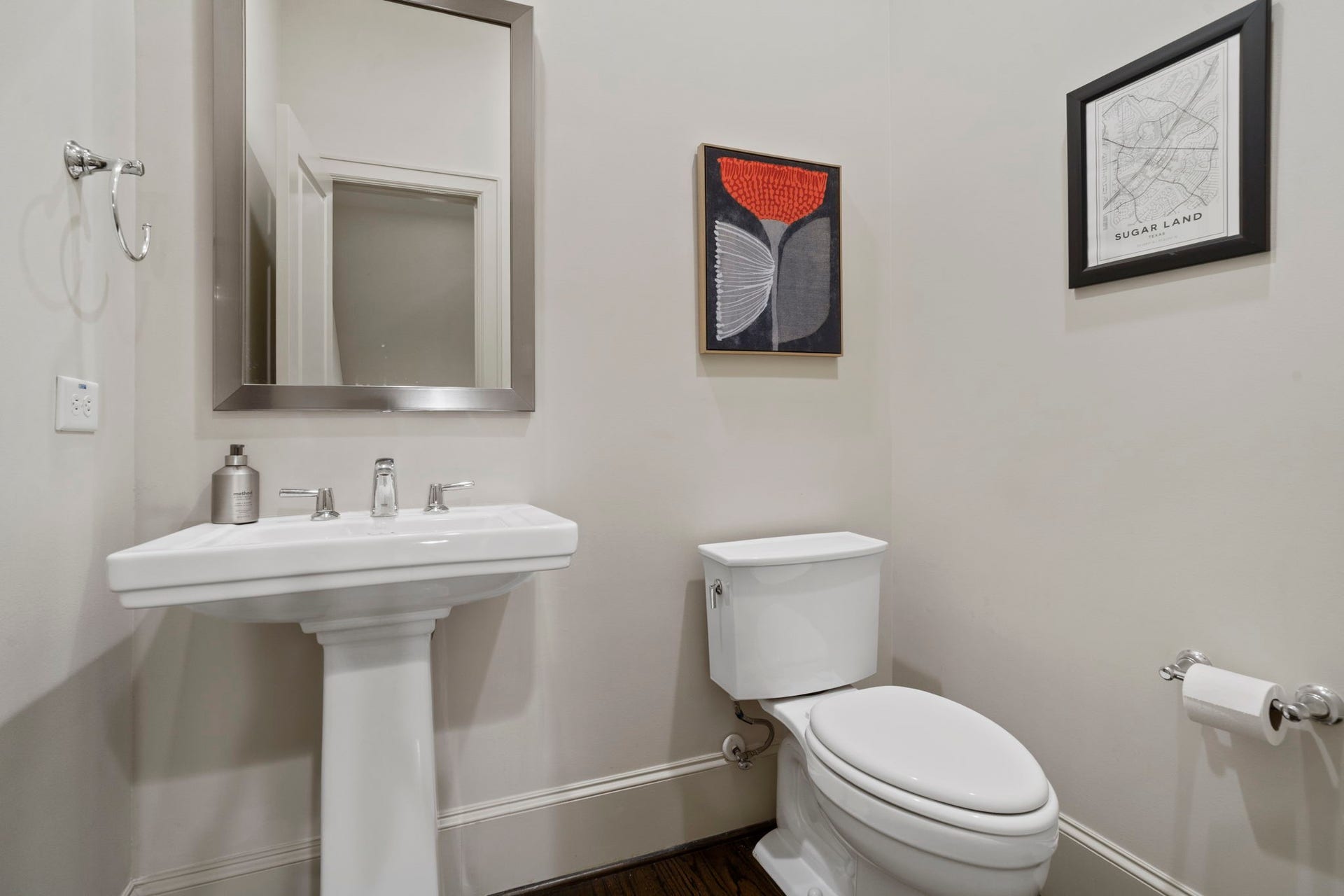 15931 Morgan Street, Sugar Land, TX 77478 A guest bathroom features a classic porcelain pedestal sink, while fixtures and finishes throughout the residence have been impeccably maintained.