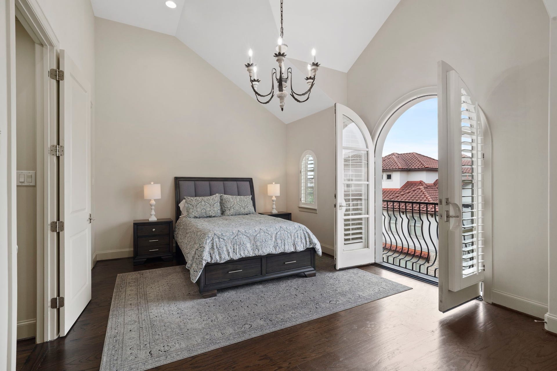 15931 Morgan Street, Sugar Land, TX 77478 The fabulous owners suite features soaring ceilings, rich hardwood flooring, and arched French doors opening to a charming Juliet balcony.