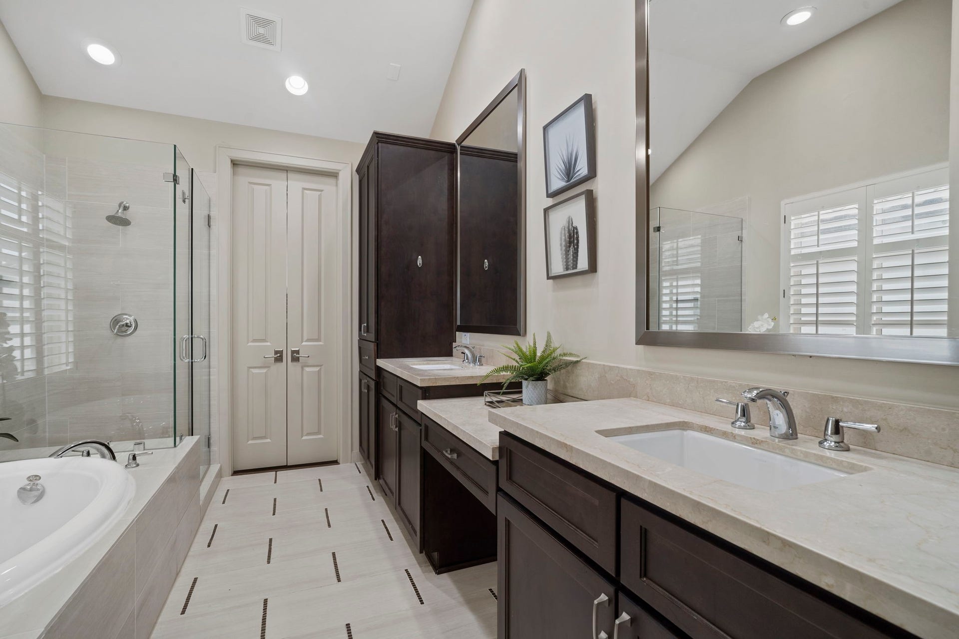 15931 Morgan Street, Sugar Land, TX 77478 The primary ensuite bath offers an expansive dual vanity with a makeup station, a jetted deep soaking tub, a glass walk-in shower, and a sizable walk-in closet. The bedroom also features a second walk-in storage closet.