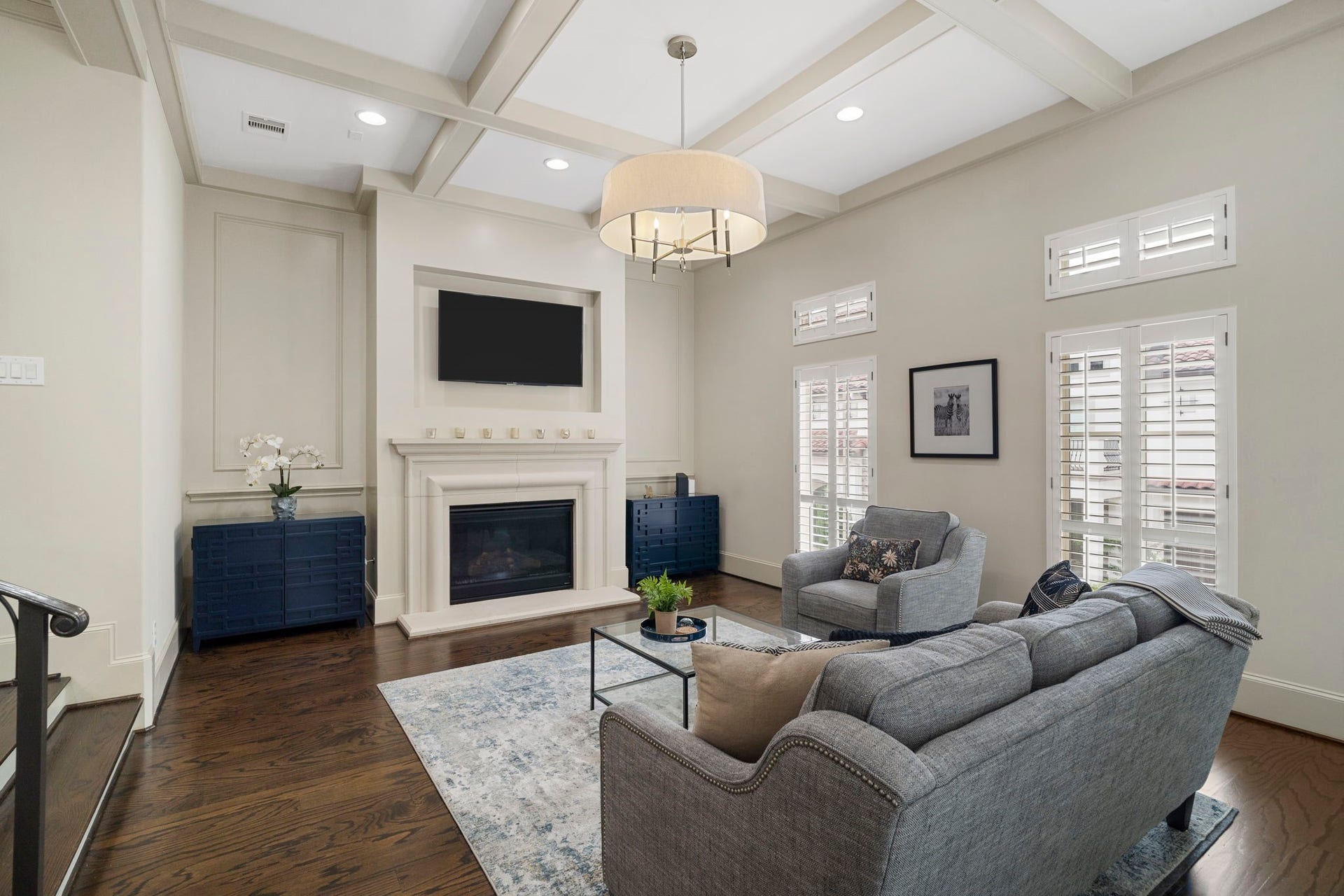 15931 Morgan Street, Sugar Land, TX 77478 High coffered ceilings and expansive windows fill the space with natural light, creating a bright, airy, and inviting atmosphere.