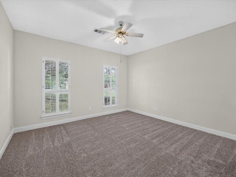 32719 Weybridge Street, Fulshear, TX 77441 One of the secondary bedrooms. It features new carpet and fresh paint.