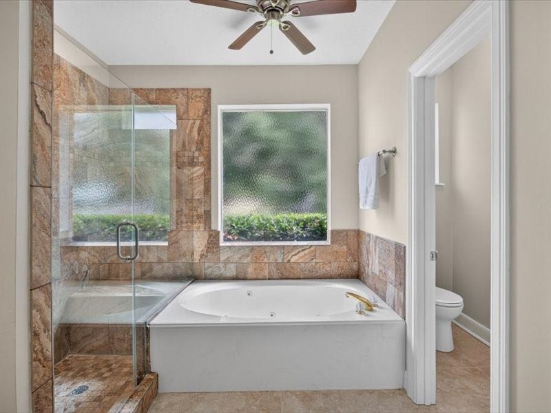 32719 Weybridge Street, Fulshear, TX 77441 The bathroom includes a large walk-in shower and soaking tub.