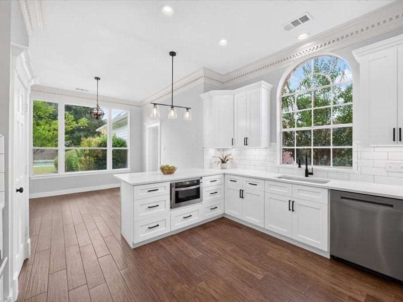 32719 Weybridge Street, Fulshear, TX 77441 The kitchen has multiple windows to bring in natural light.
