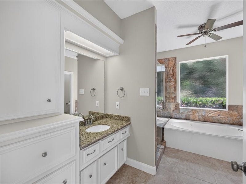32719 Weybridge Street, Fulshear, TX 77441 The primary bathroom features lots of cabinet space, granite counters and double sinks.