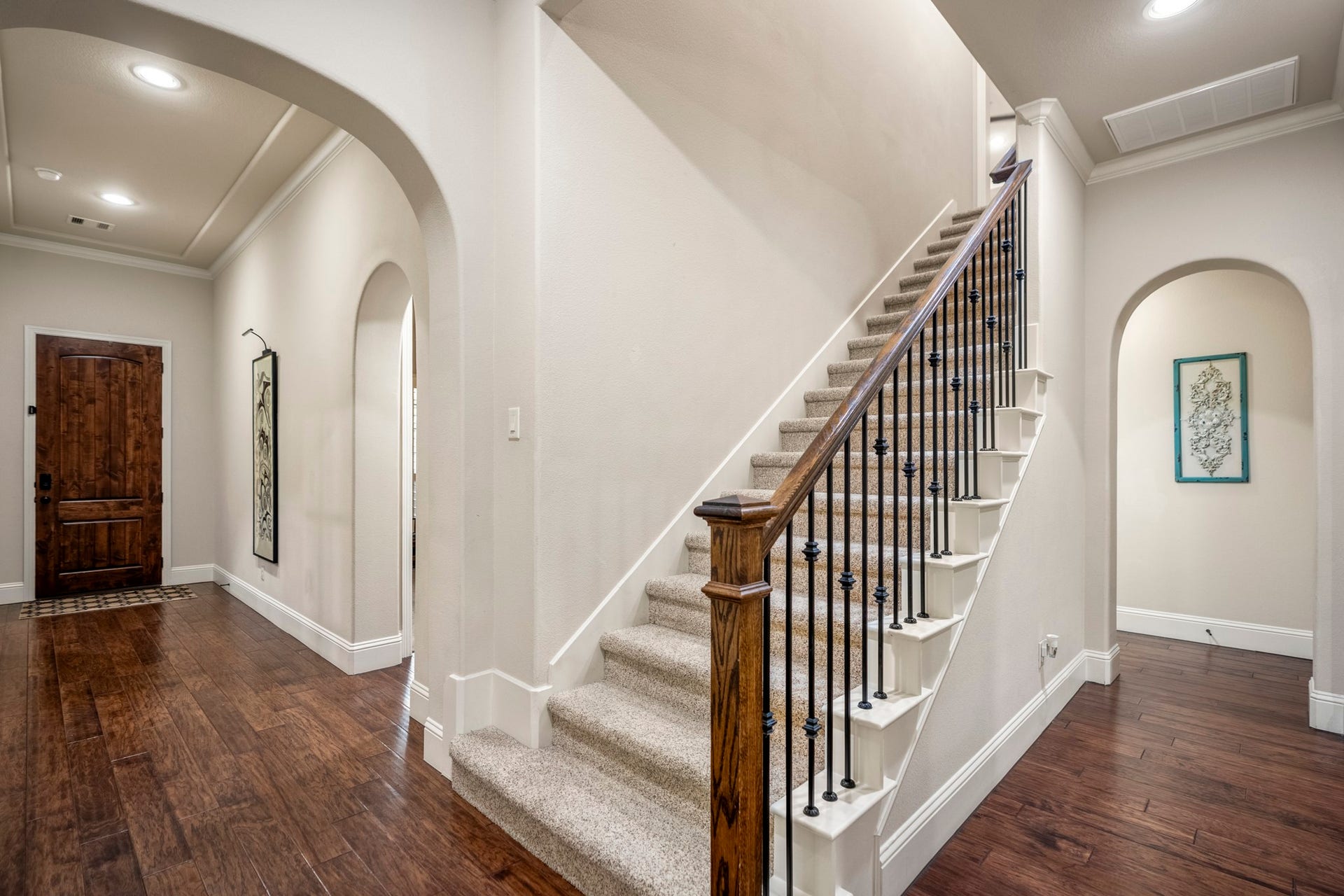 Architectural charm shines with graceful arches, crown molding, and a beautifully crafted staircase.