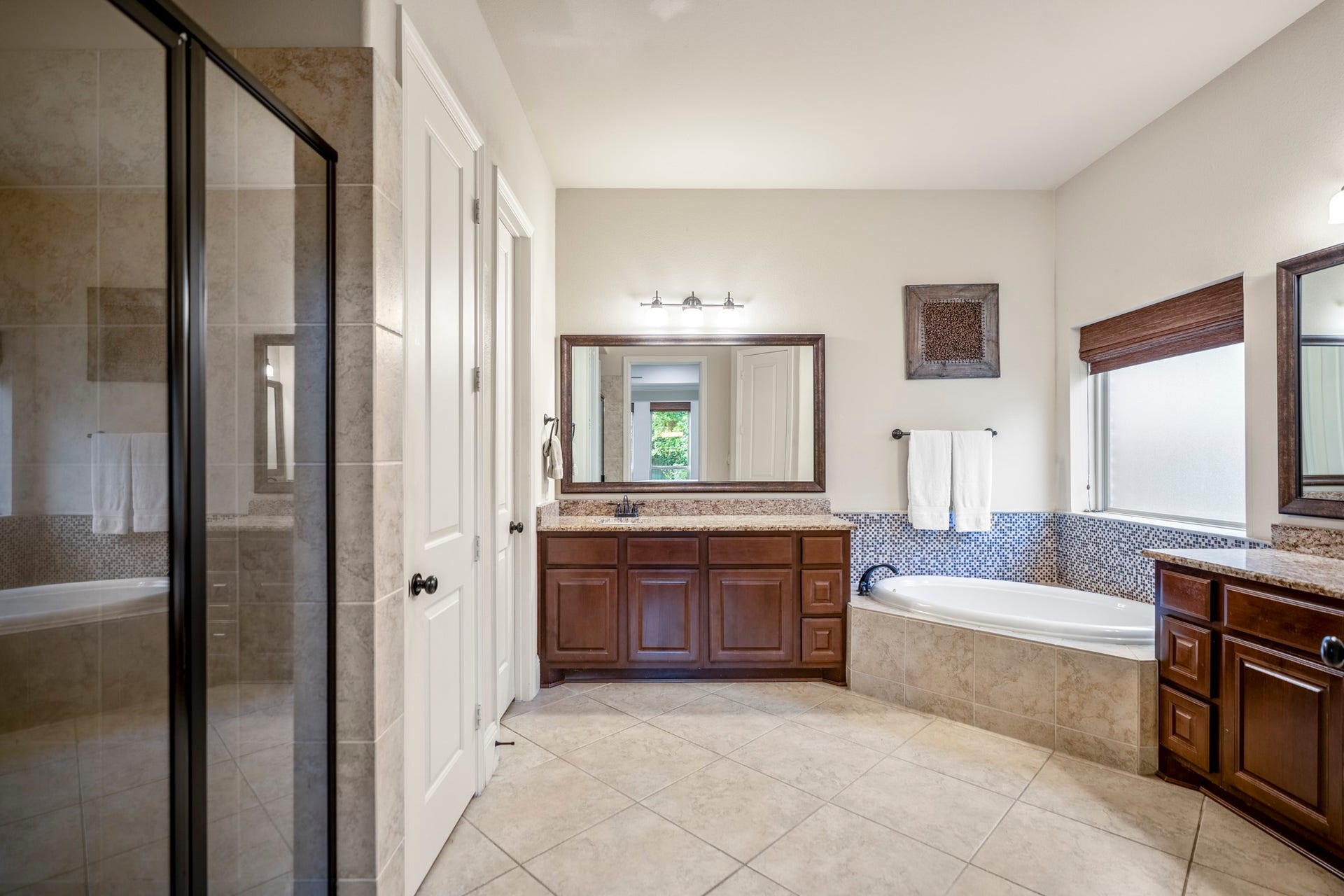 Here is your spa-like ensuite featuring a soaking tub, separate shower, and generous walk-in closet