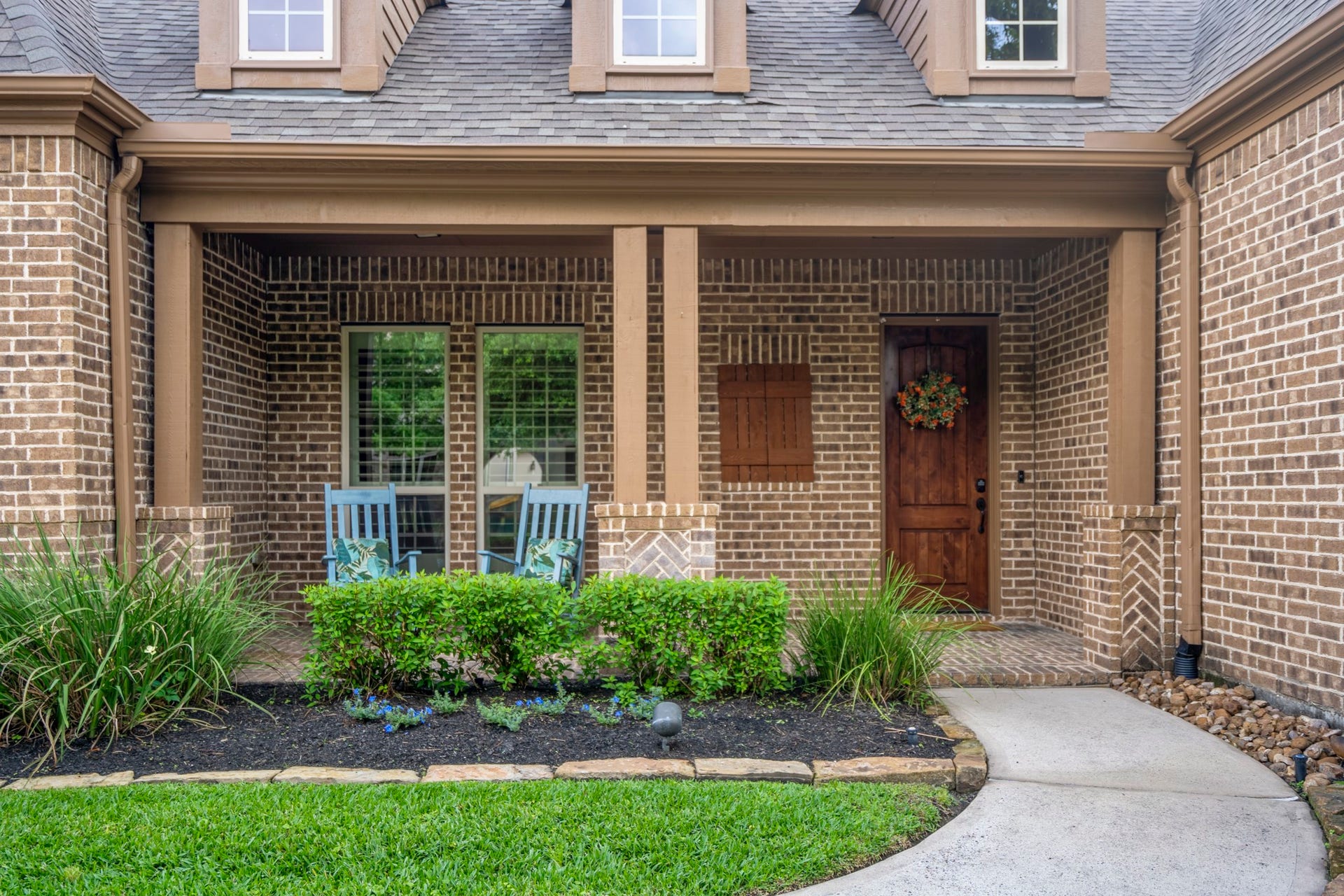 With a classic brick exterior, warm wood shutters and a welcoming covered front porch, this home has curb appeal that makes a lasting impression.