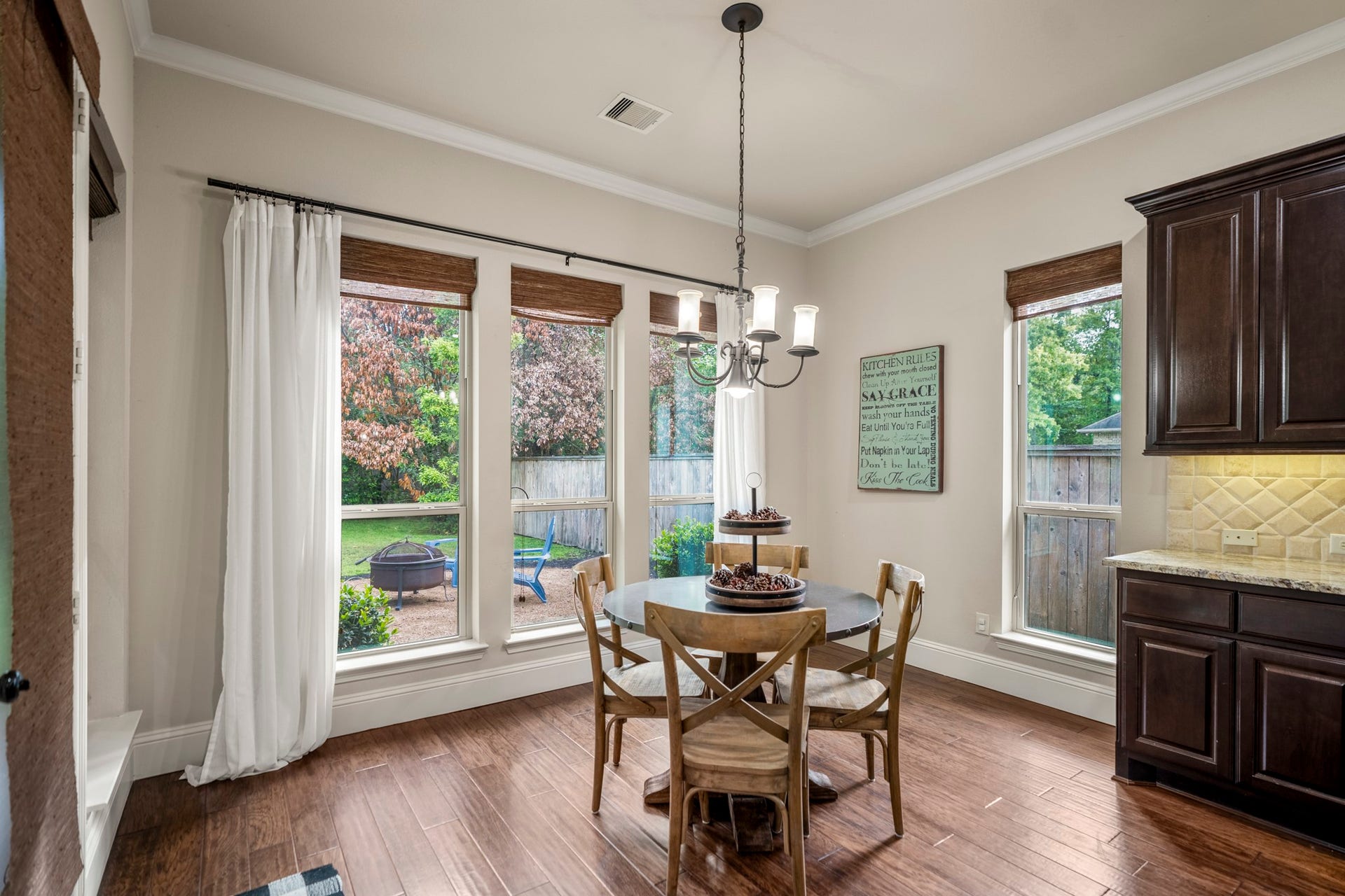 The breakfast area, bathed in light, is the ideal spot for casual mornings overlooking your spacious lot.