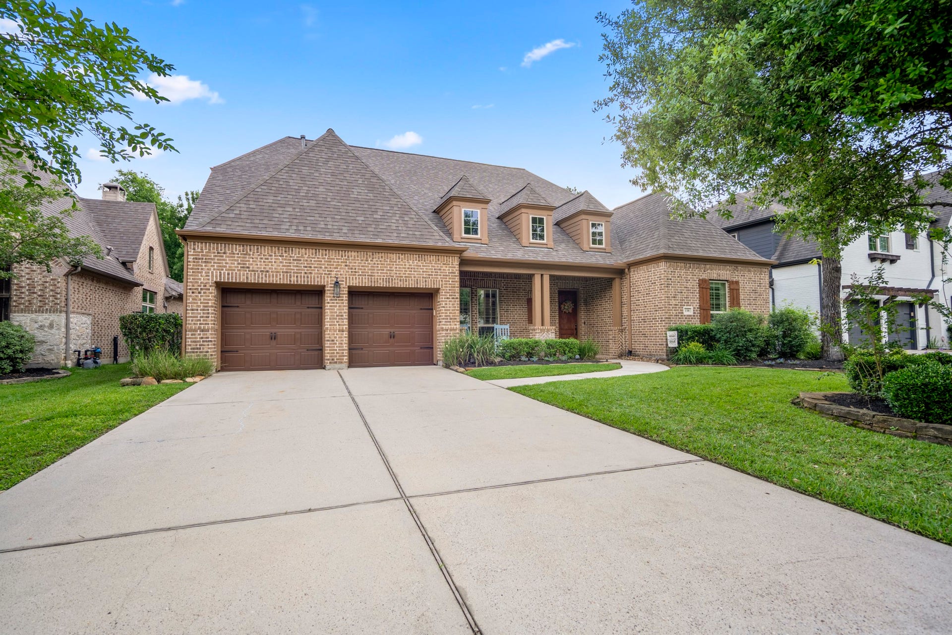 The three-car tandem garage offers flexible space for vehicles, storage, or even a golf cart.