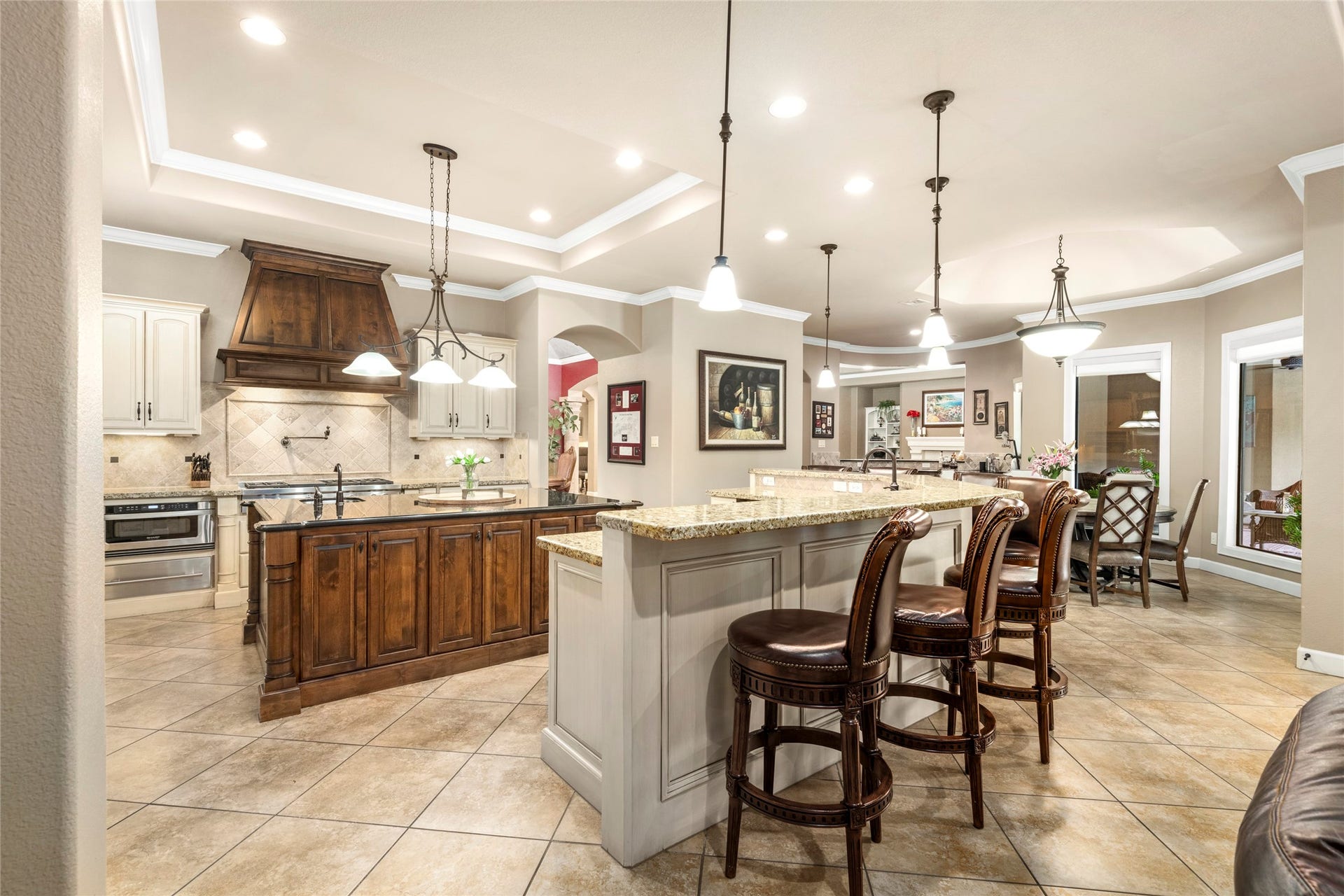 The kitchen showcases oversized detail, a huge island & breakfast bar, and gourmet finishes ideal for casual meals and entertaining.