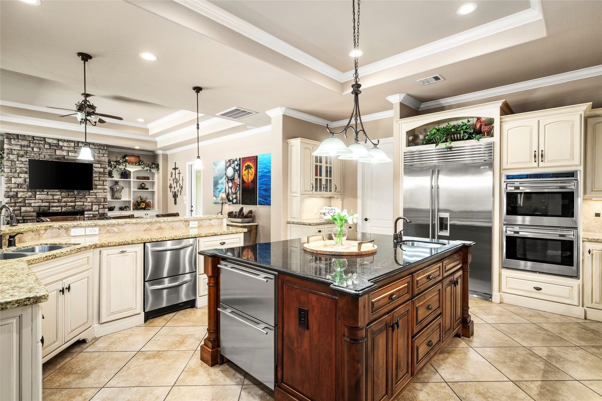 Ample counter space with beautiful granite, stainless custom appliances including double dishwasher drawers,two refrigerator drawers, double ovens and an extra sink on the island, no detail spared.