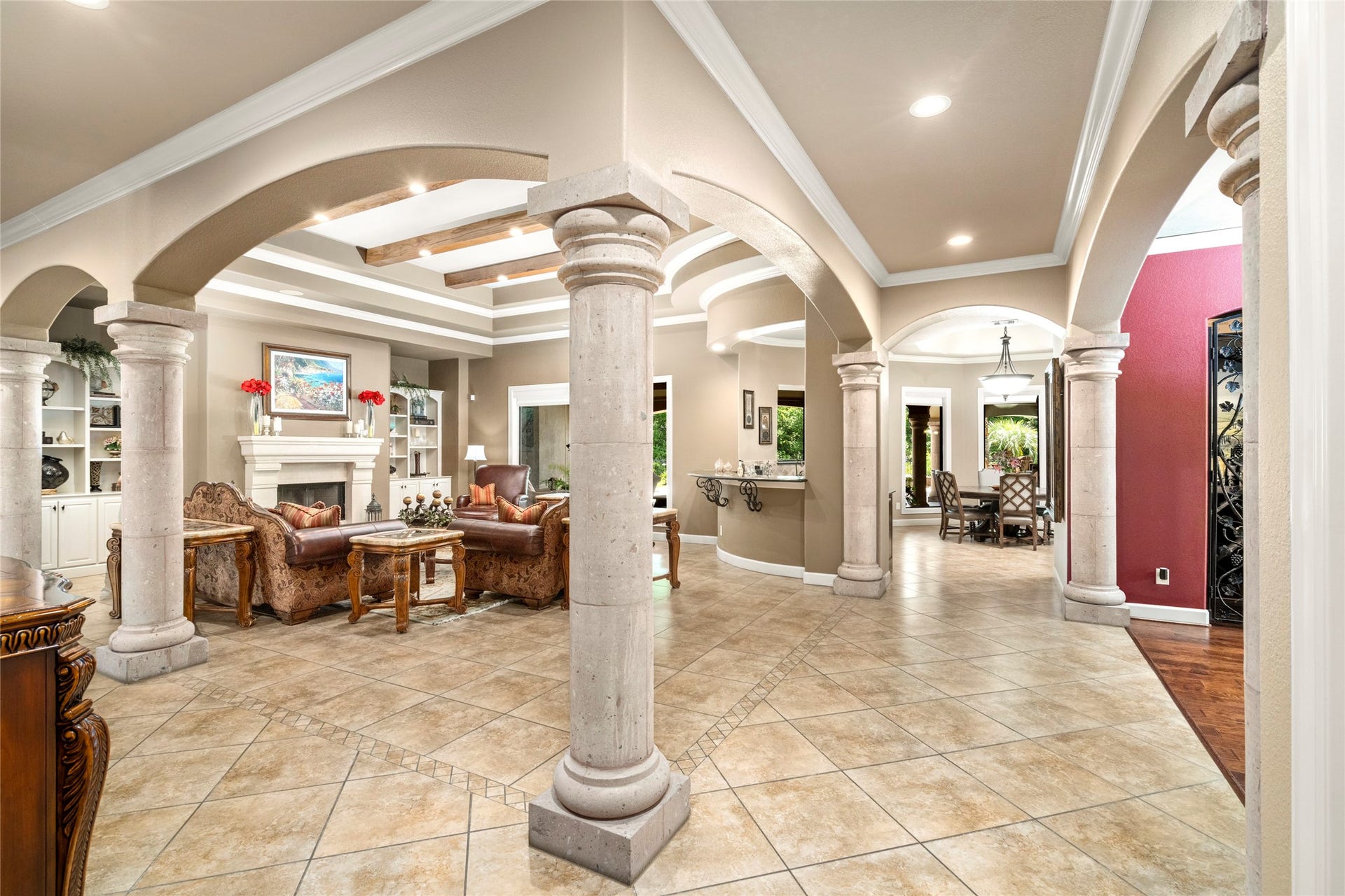 The stone columns showcase the home's architectural craftmanship, a defining element of its timeless beauty.