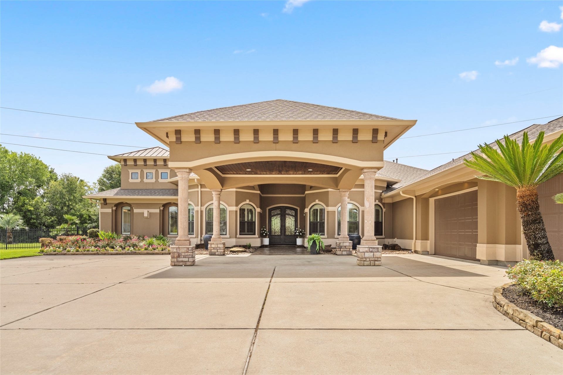 As you enter, a gracious porch welcomes you with gorgeous iron double leaded glass doors.