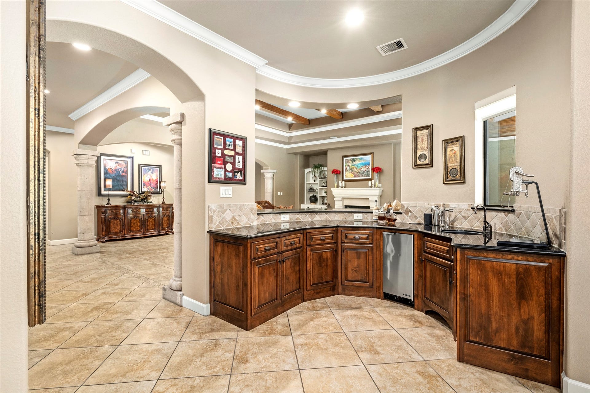 The large wet bar area can double as a convenient serving station, perfectly situated for effortless entertaining.