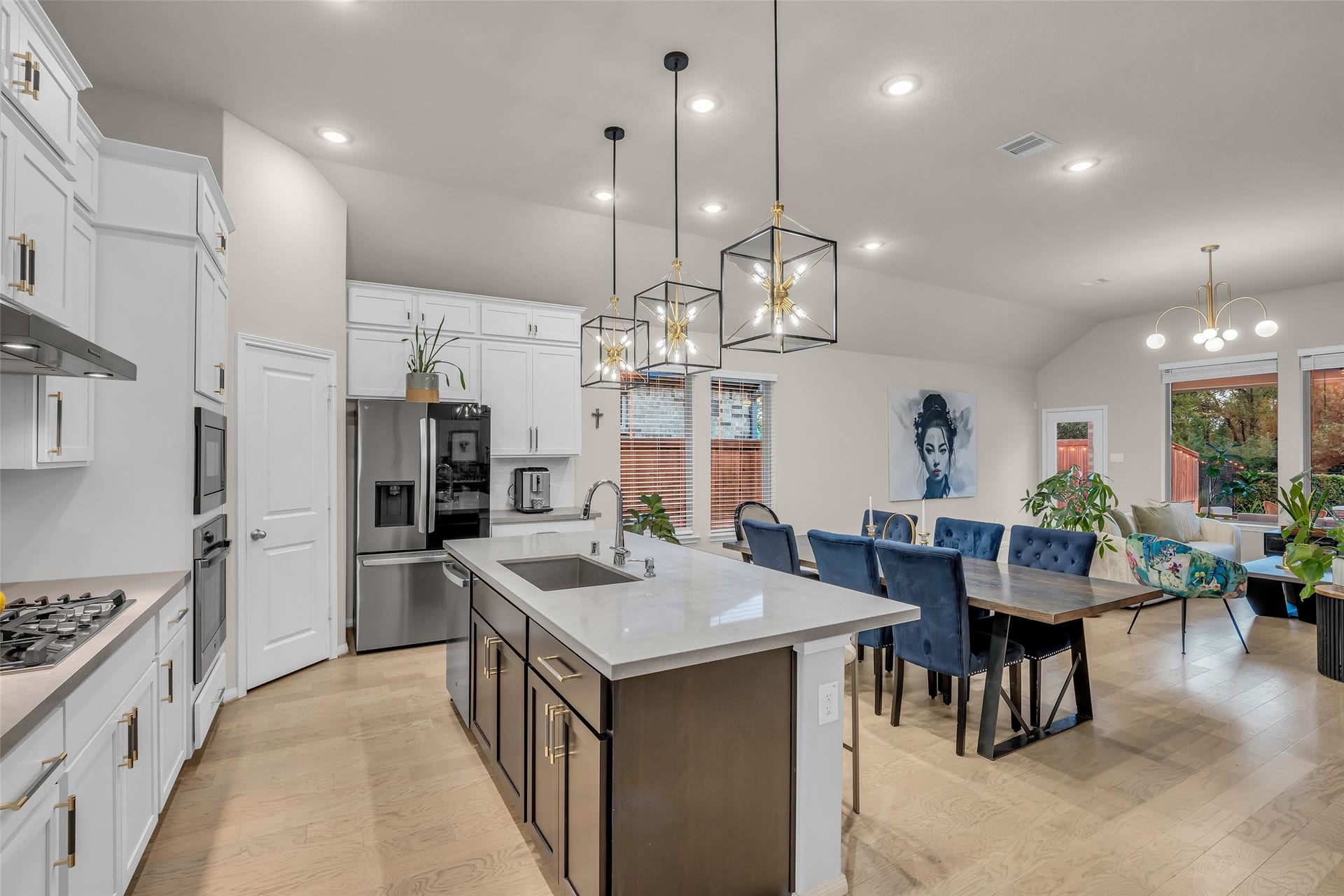 A sophisticated kitchen featuring quartz countertops, stainless steel appliances and a stunning oversized island designed for effortless entertaining.
