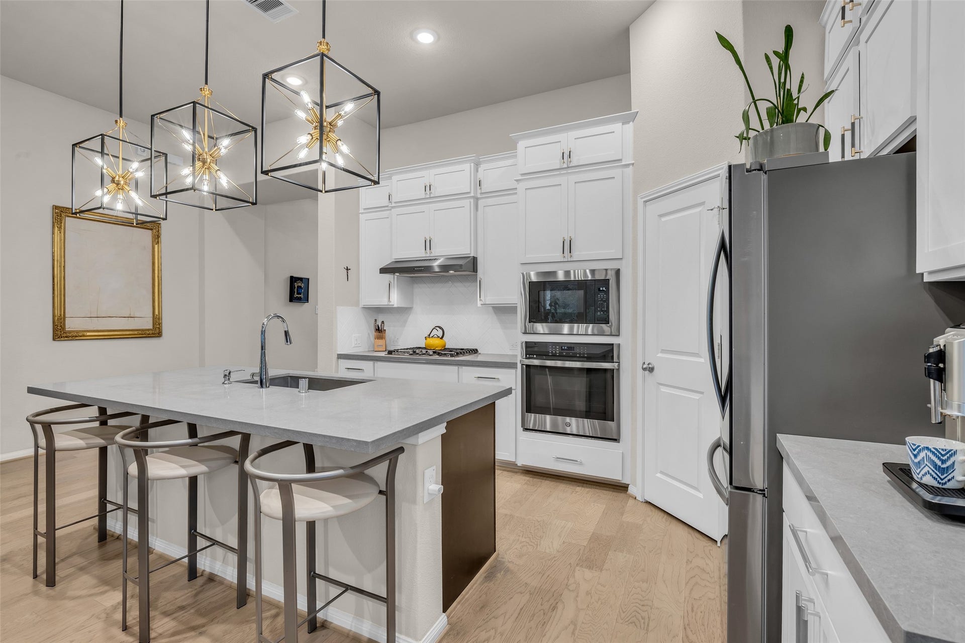 Built-in oven, microwave, a stainless refrigerator and generous counter space keep meal prep easy.