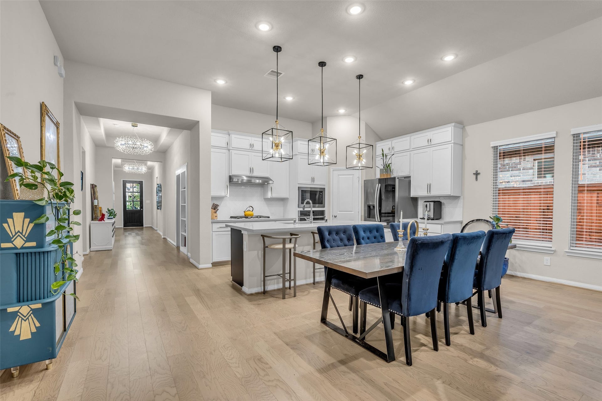 The dining area sits at the heart of the open floor plan, with views straight through to the front entry.