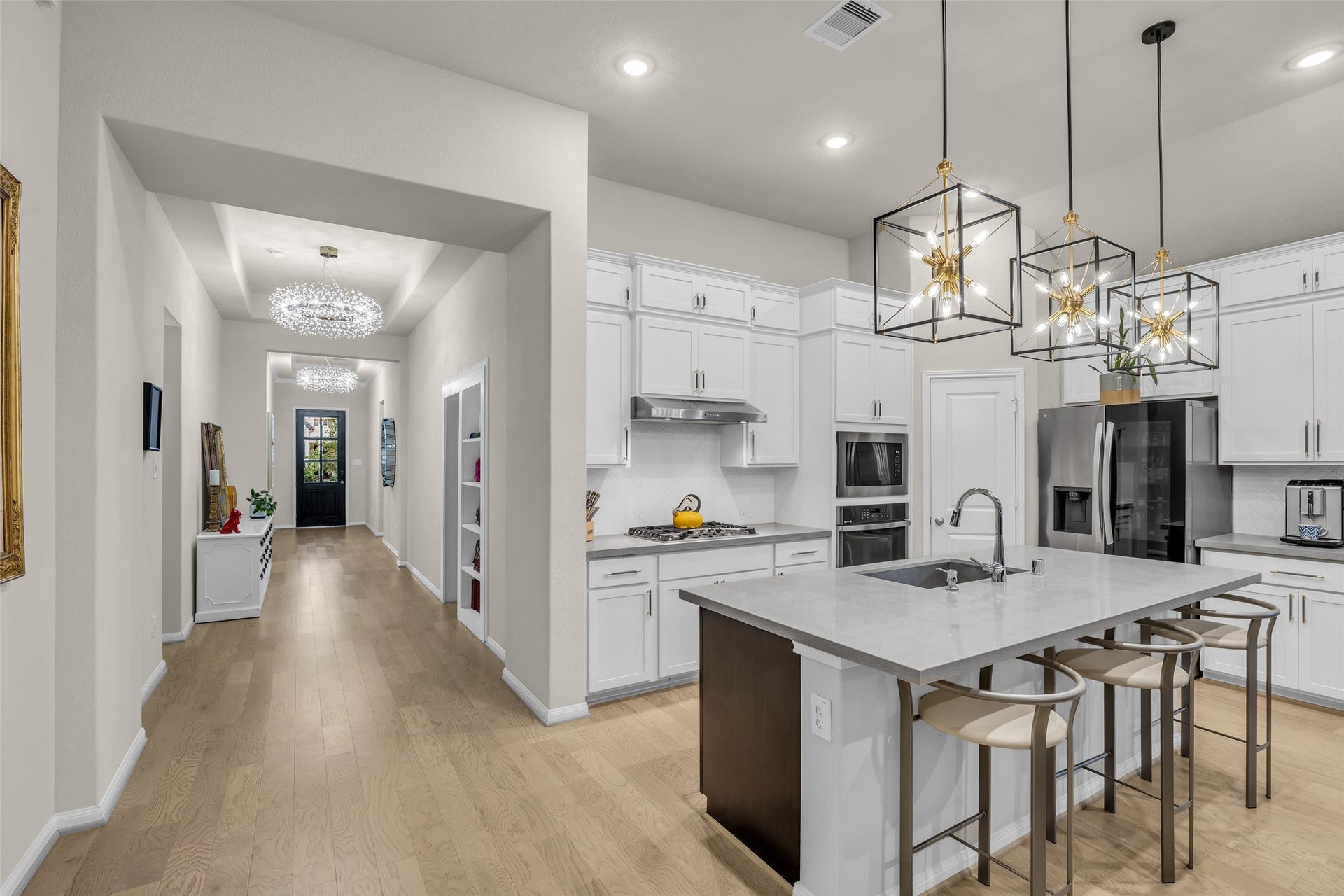 Pull up a stool at the oversized island with breakfast bar seating and a deep undermount sink.