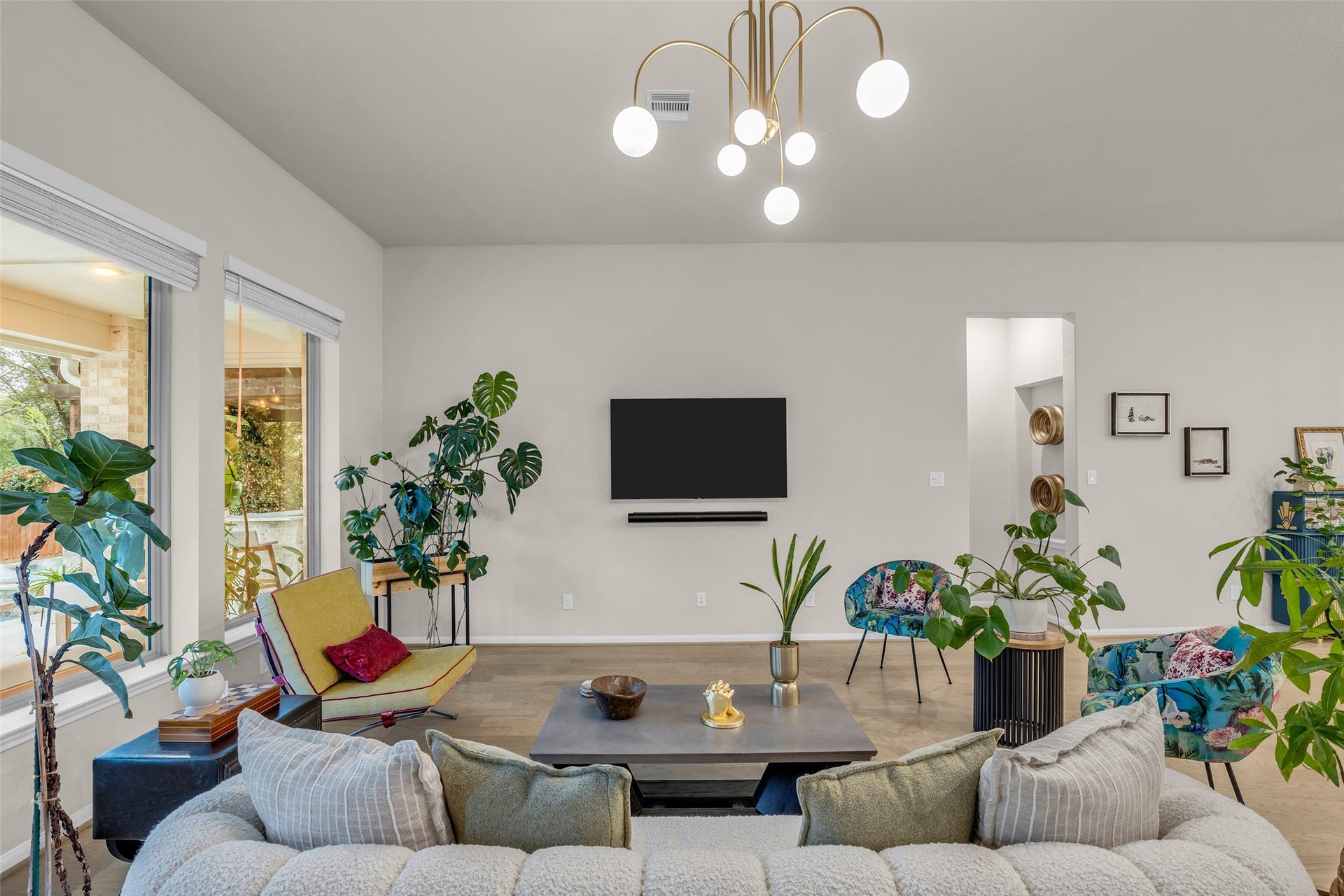 Soaring ceilings, statement lighting and expansive windows elevate this light-filled living space.