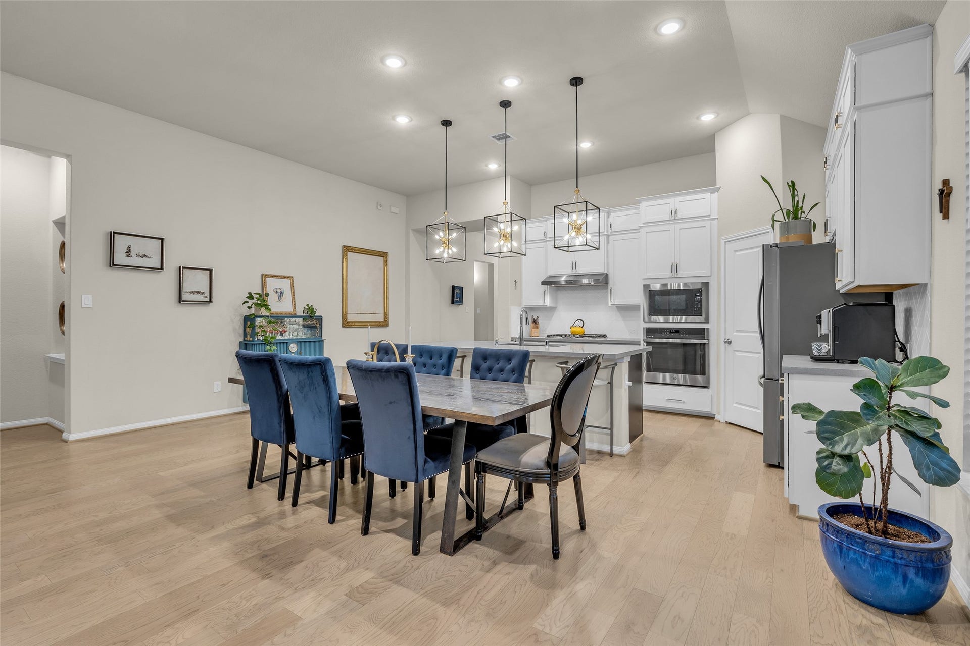 Room for a large table, with the kitchen and its statement pendant lights just behind.