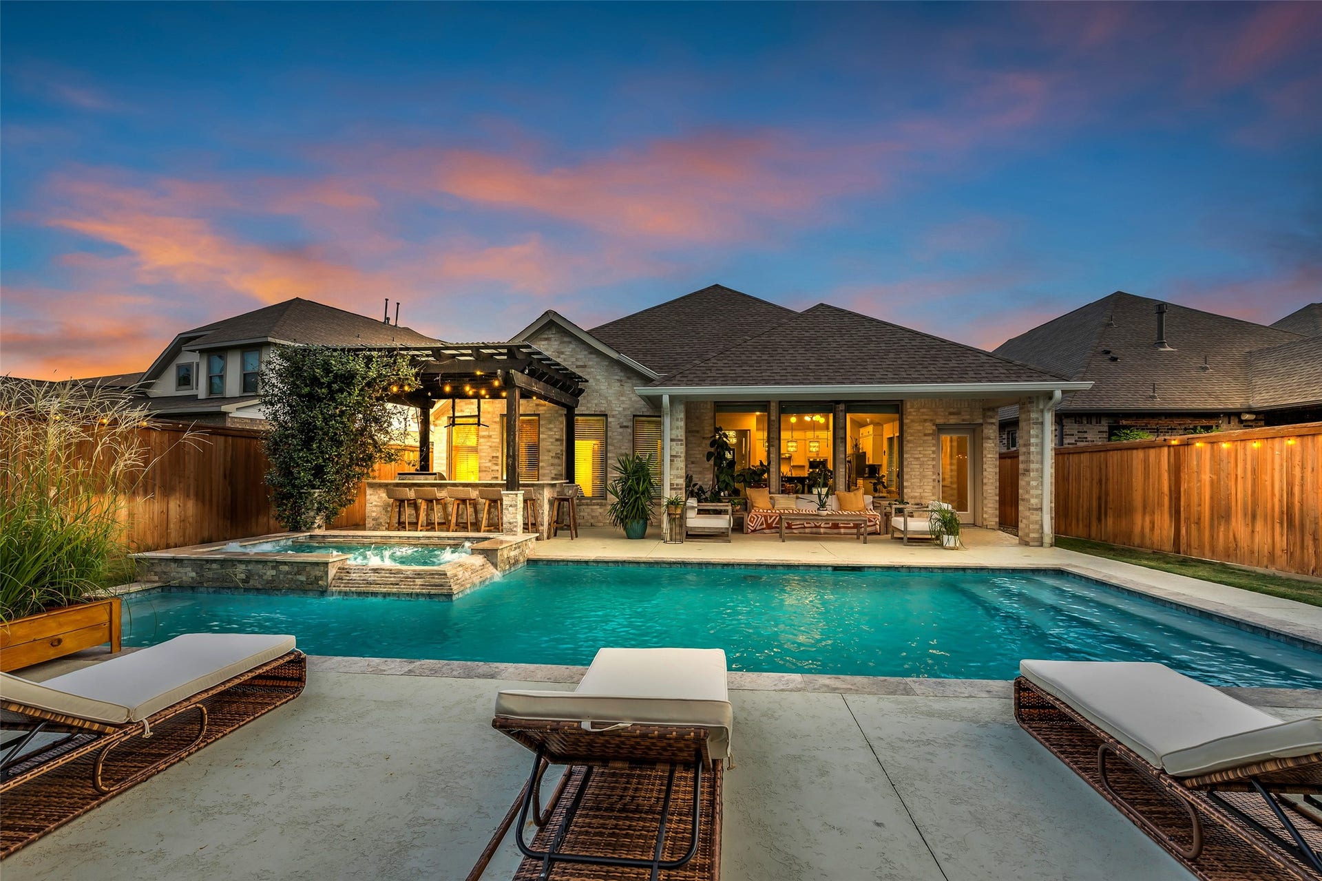 Evening swims and poolside dinners come easy with the glowing home just steps away.