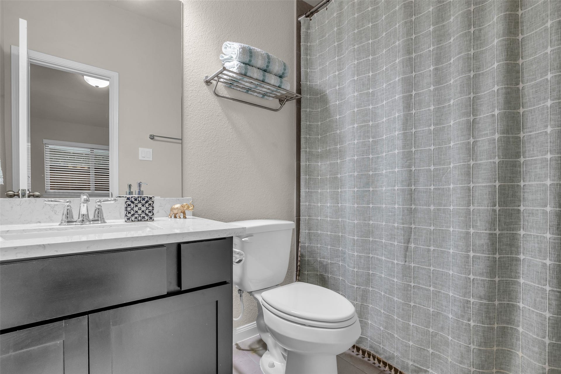 A second full bath with a dark-wood vanity and tub/shower combo.