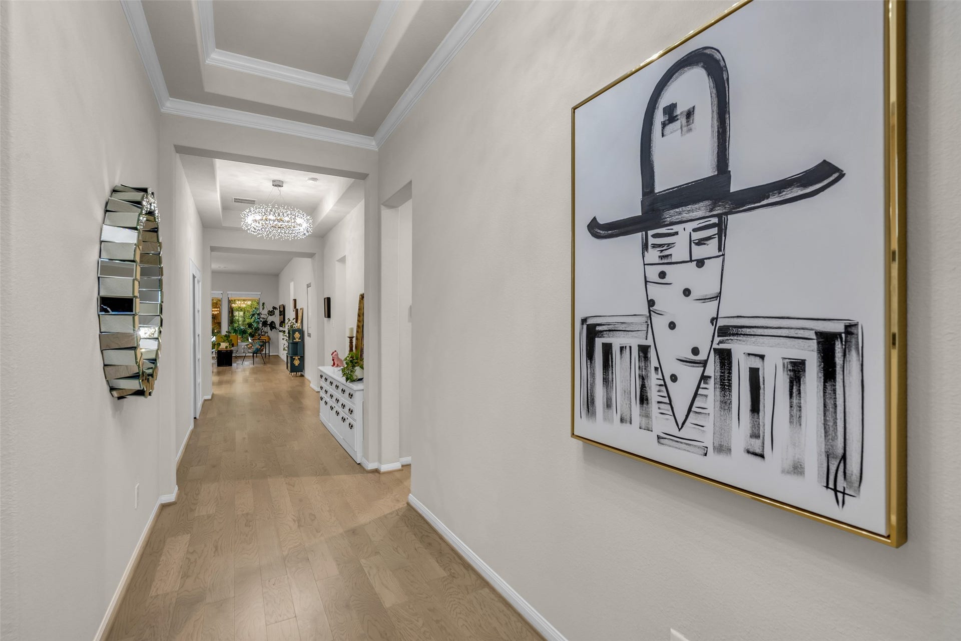 A grand gallery-style entry with a tray ceiling creates a striking first impression.