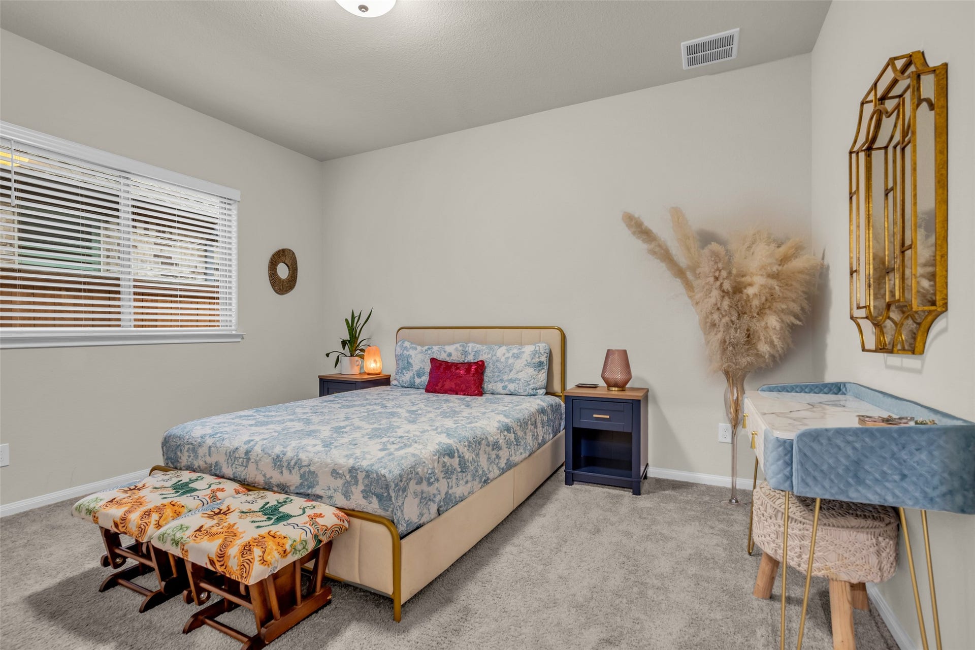 A bright secondary bedroom with room for a bed, desk and vanity.