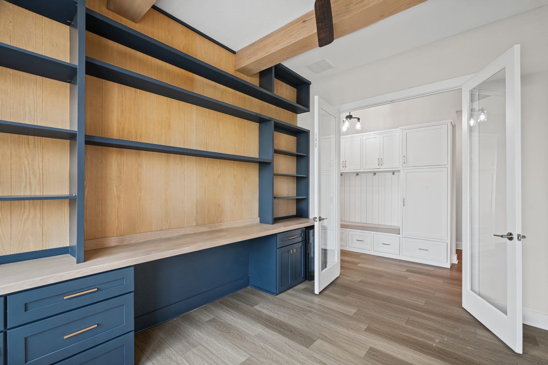 Another look at the study's custom cabinetry and shelving, with a door to the main hall that keeps the room private while staying just steps from the front entry.