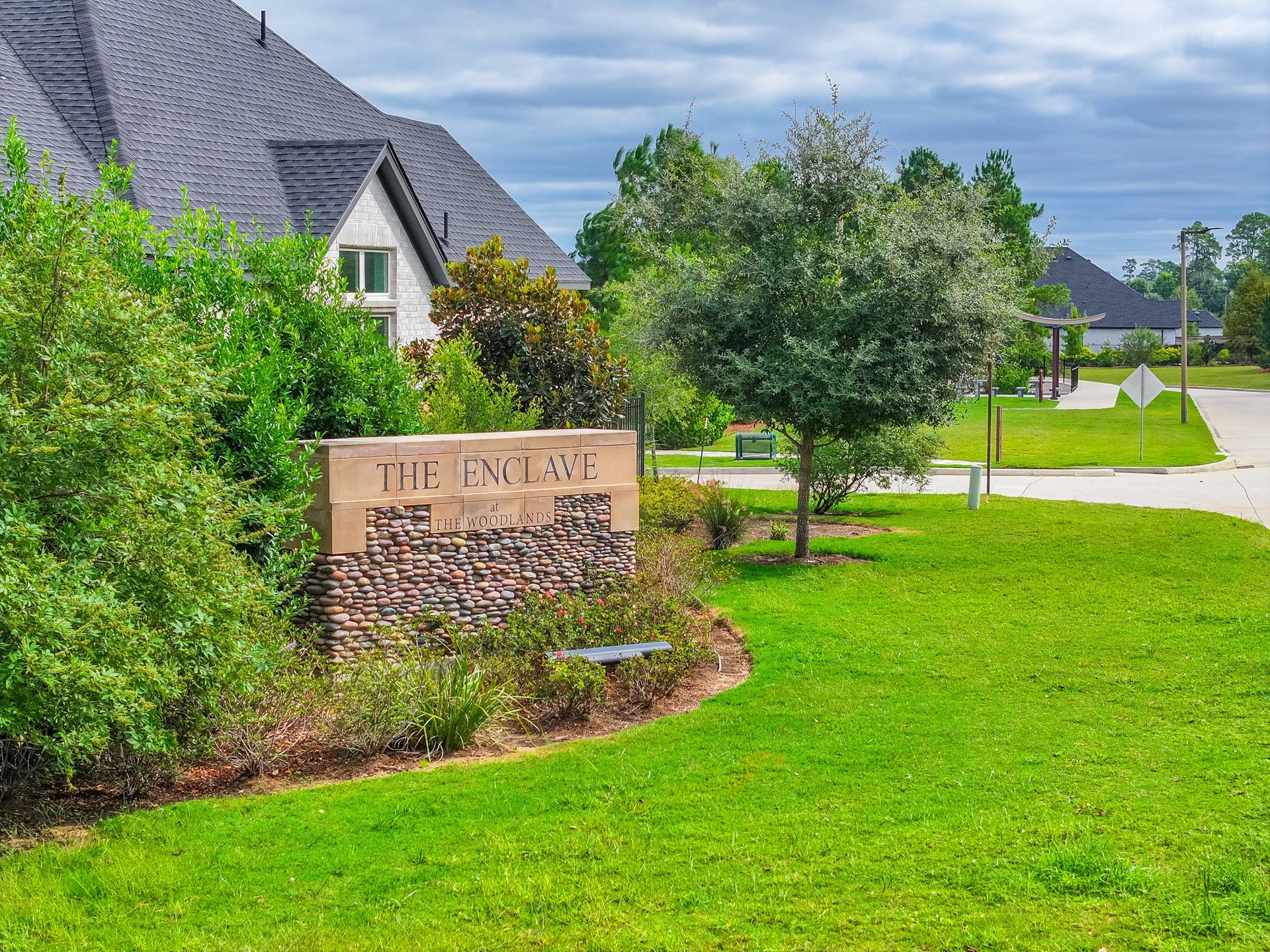 The community's landscaped entrance and green space set the tone for the neighborhood, with sidewalks, mature trees and well-maintained common areas throughout.
